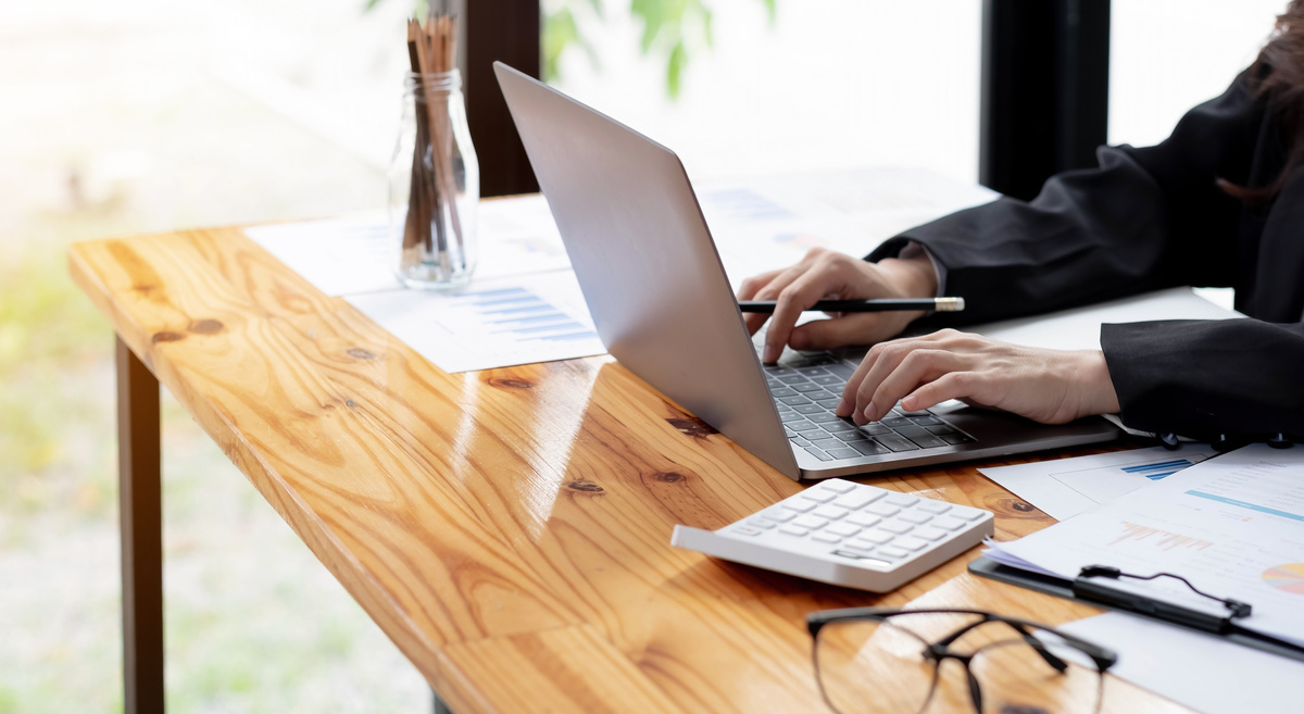 Close up Business Woman Using Calculator and Laptop for Do Math